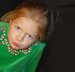 Child making a mad face at their dry cleaning for messing up