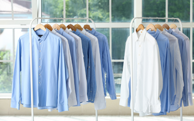 freshly laundered shirts hanging on a rack